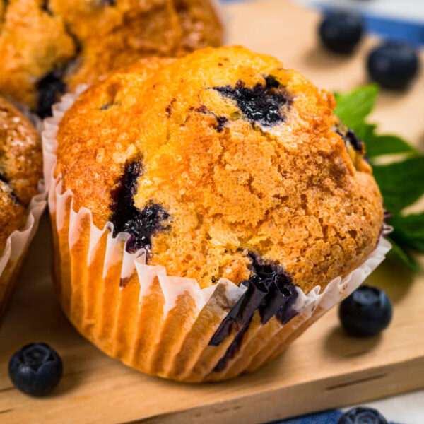 Blueberry muffins with fresh blueberries on wooden background. selective focus.